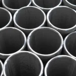 piezas de tubo de acero inoxidable apiladas en un almacen